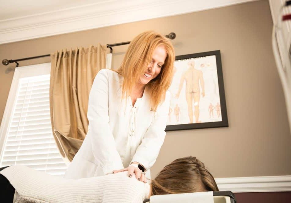 Dr. Deb giving a back massage to patient.