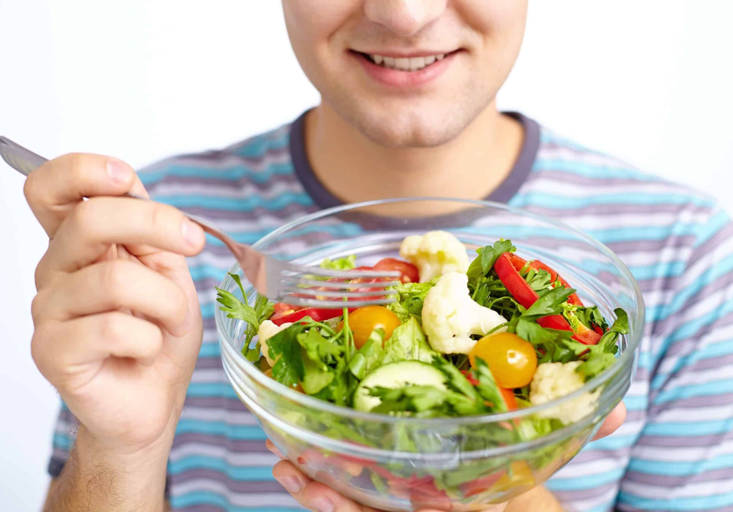 close-up-of-fresh-vegetable-salad-being-eaten-by-man