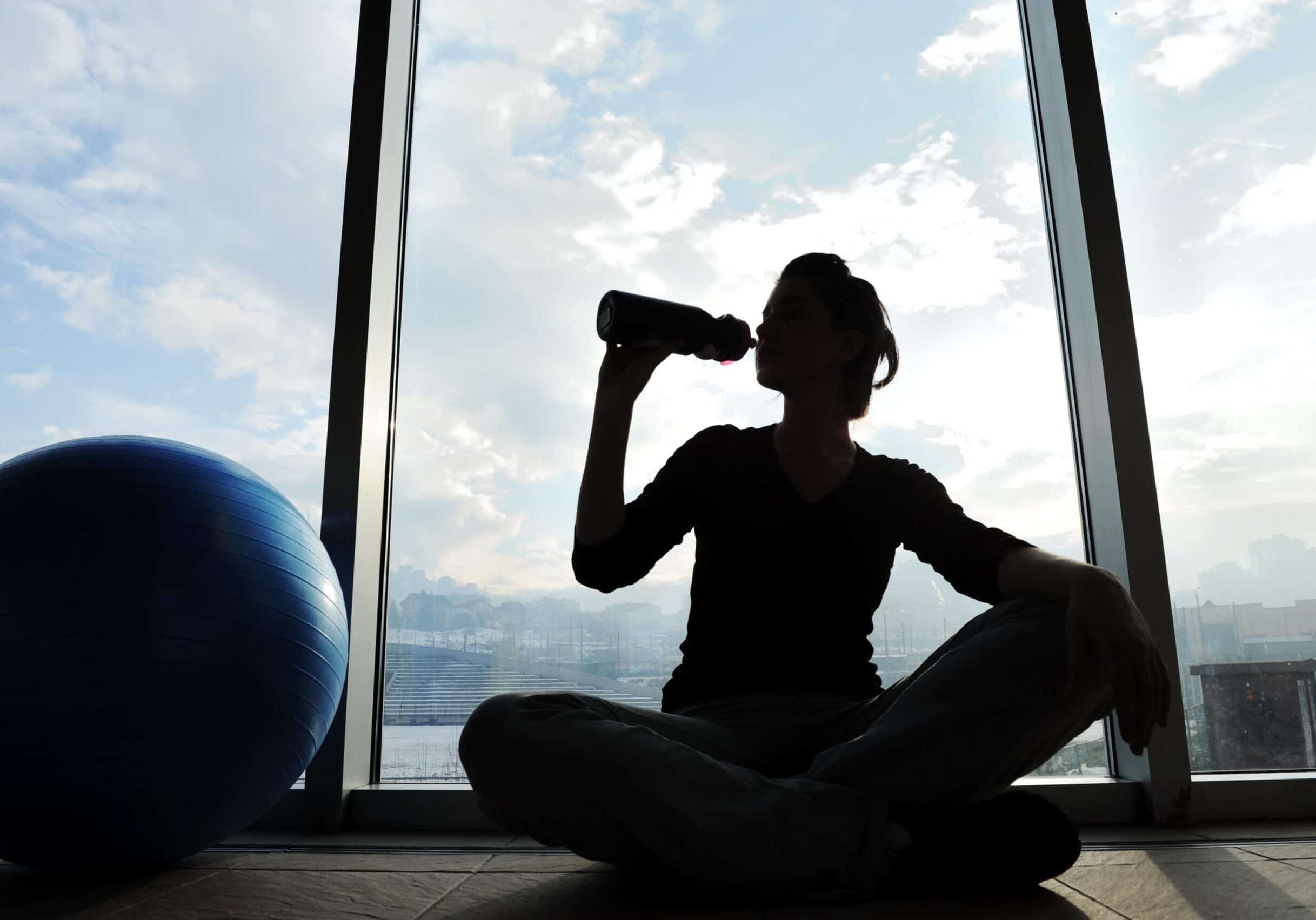 fitness sporty girl silhouette exercising and drinking water
