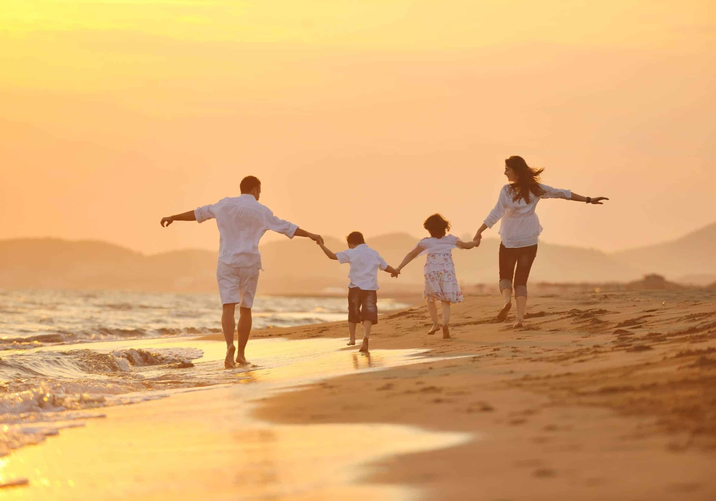 joyful-family-enjoying-beach-at-sunset