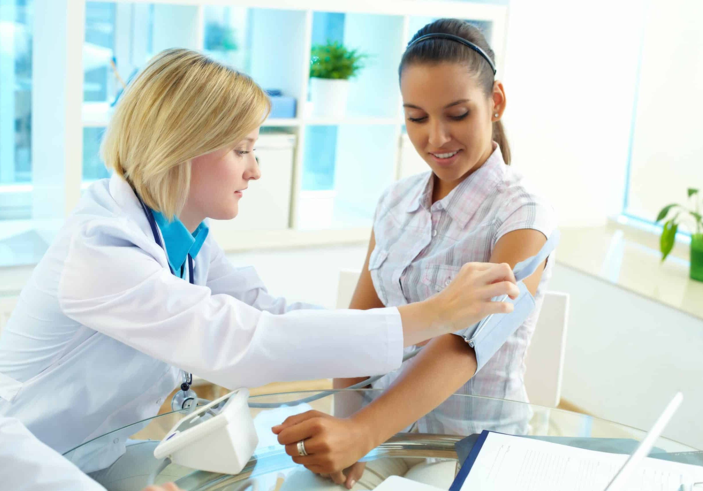portrait-of-confident-practitioner-measuring-blood-pressure-of-patient